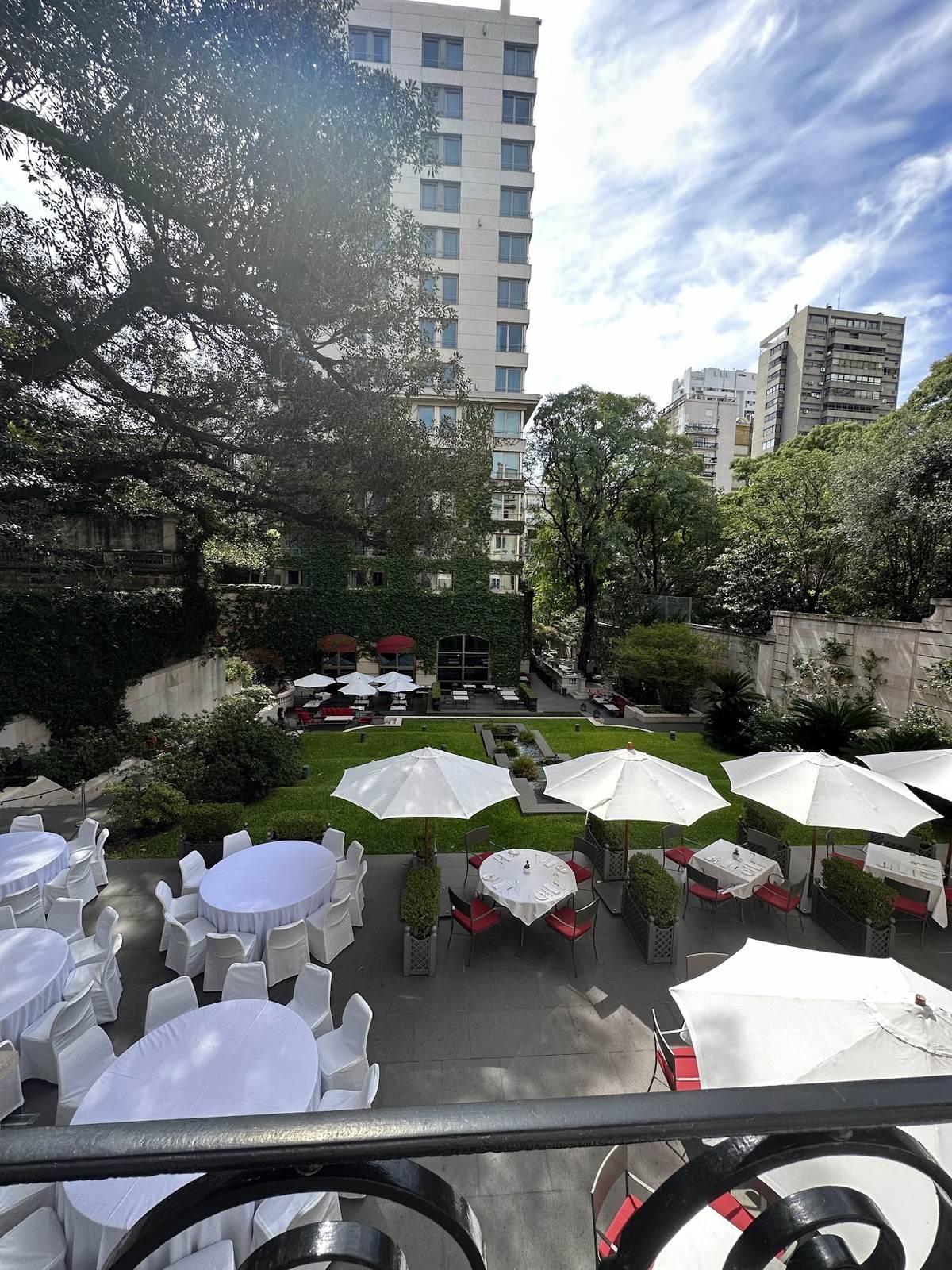 The garden terrace at Palacio Duhau looking toward the modern Park Hyatt tower across the property